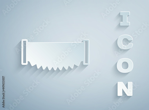 Paper cut Two-handed saw icon isolated on grey background. Paper art style. Vector