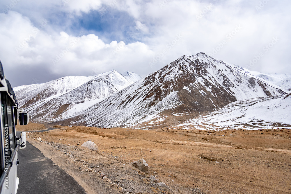 Beautiful panoramic view of a mountainside lit at the sunset period and also including of a snow found high up in the mountain peaks. Beautiful panoramic view of a mountainside lit at the sunset period and also including of a snow found high up in the mountain peaks.