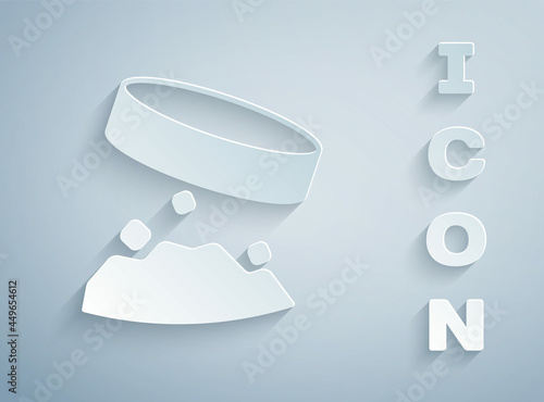 Paper cut Giant magnet holding iron dust icon isolated on grey background. Paper art style. Vector