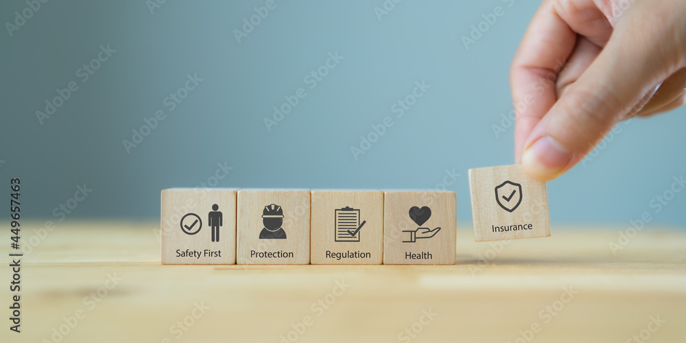 Safety Taskbar Images Safety at work concept. Hand holds cubes wooden block with safety icons ...