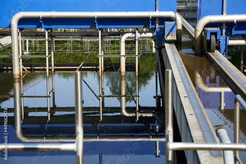Wastewater treatment plant (Kläranlage) in germany, blue steel construction with pipes and rails. Filters dirty water from water bodies.