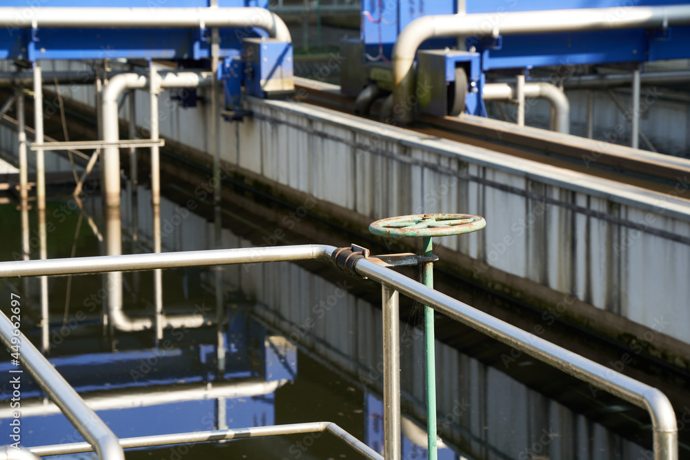 Wastewater treatment plant (Kläranlage) in germany, blue steel construction with pipes and rails. Filters dirty water from water bodies. Side view. Wastewater treatment plant (Kläranlage) in germany, blue steel construction with pipes and rails. Filters dirty water from water bodies. Side view.