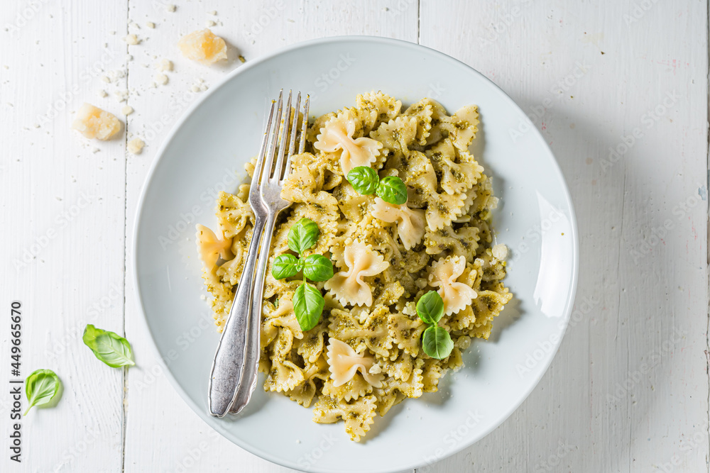 Farfalle pasta with green pesto and basil. Classic Italian dinner. Farfalle pasta with green pesto and basil. Classic Italian dinner.