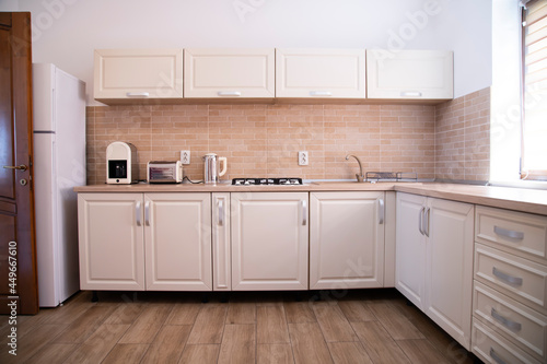 Cozy bright kitchen interior with wooden furniture