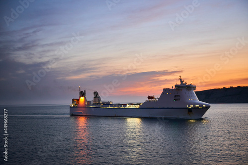 Tableau sur toile Cargo ship arriving to the Port of Bilbao at sunset, Biscay, Basque Country, Eus