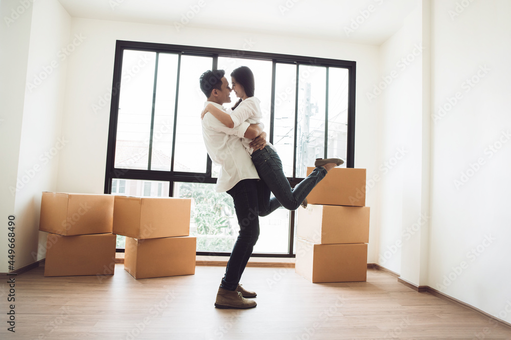 Happy couple in new house with cardboard boxes on moving day. new house concept. Happy couple in new house with cardboard boxes on moving day. new house concept.