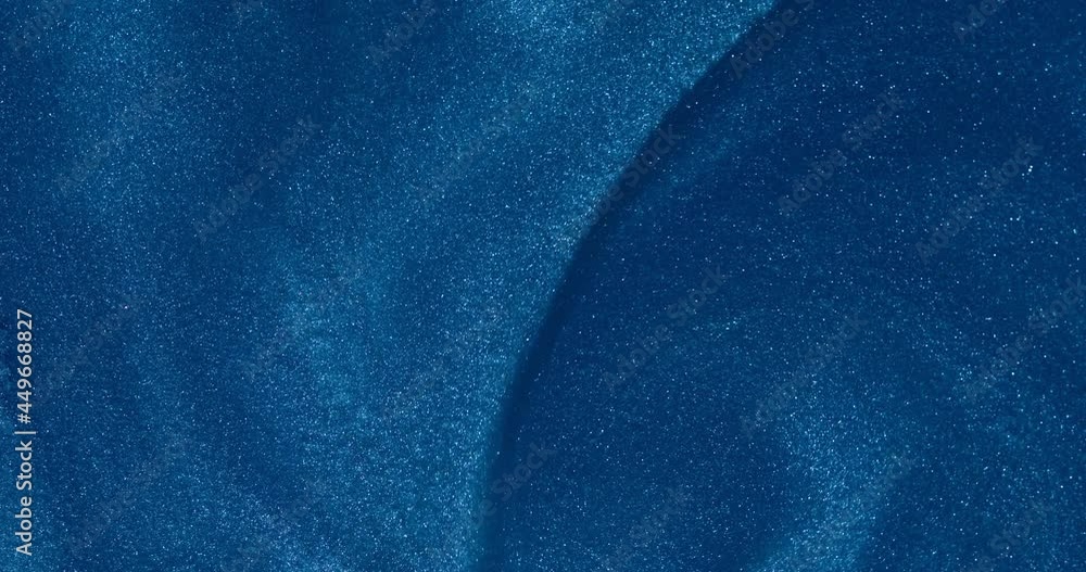 The blue glittering water slowly flows into beautiful abstract patterns