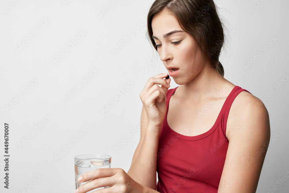 woman holding a pill glass of water taking medicine treatment therapy woman holding a pill glass of water taking medicine treatment therapy