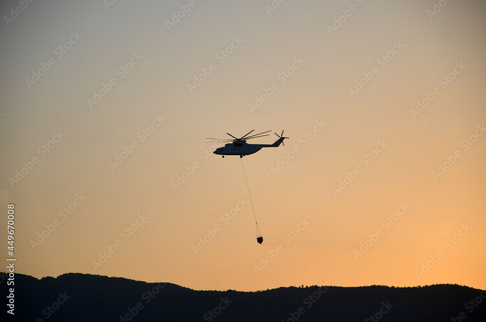 Russian helicopter draws water from the sea to extinguish a forest fire. Marmaris,Turkey Russian helicopter draws water from the sea to extinguish a forest fire. Marmaris,Turkey