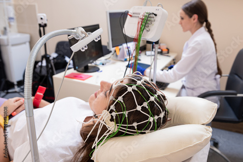 Patient brain testing using encephalography at medical center photo