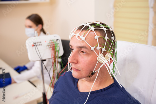 Patient brain testing using encephalography at medical center photo