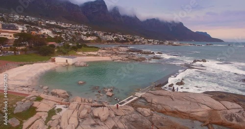 Aerial: Tidal pool in Camps Bay coastline, Cape Town, South Africa.