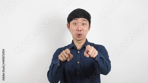 Asian man happy dancing point at you interview pass test choice concept wthie background photo