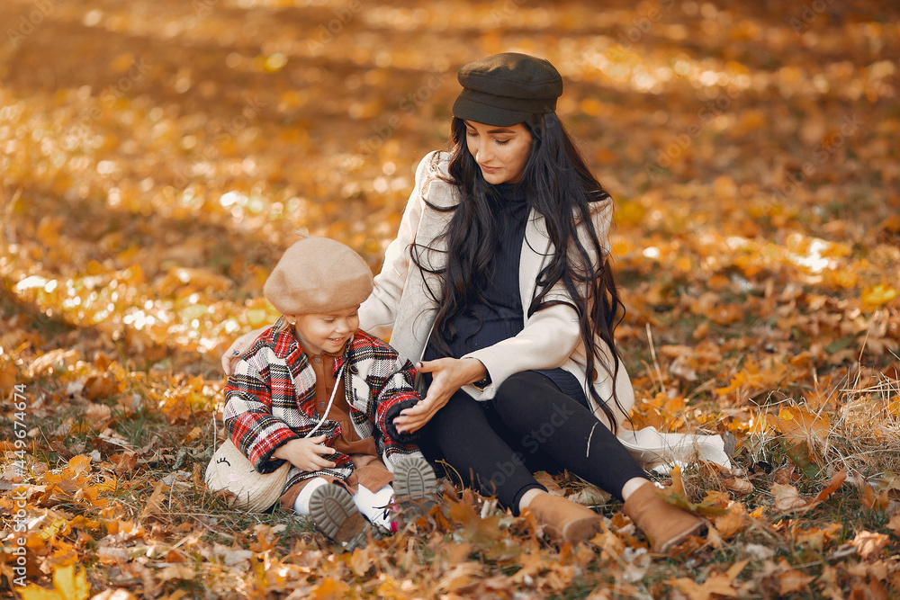 Cute and stylish family in a autumn park Cute and stylish family in a autumn park