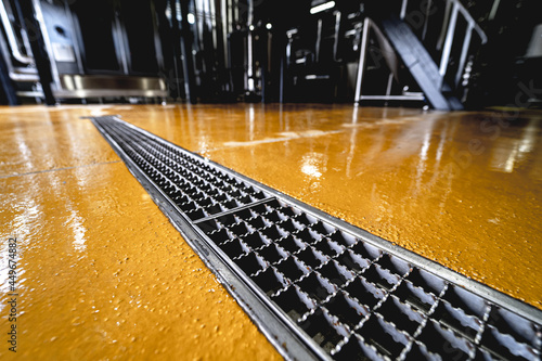 stainless steel floor drain at a modern beer factory photo