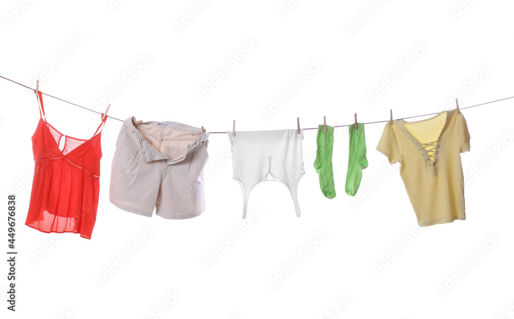 Clean clothes hanging on laundry line against white background Clean clothes hanging on laundry line against white background