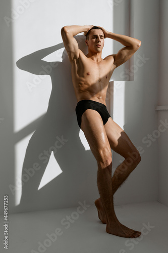 male with muscled naked body in black panties