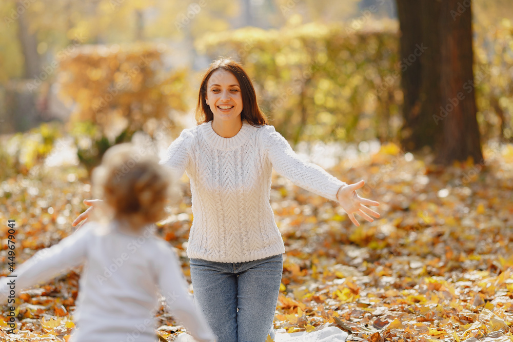 Cute and stylish family in a autumn park Cute and stylish family in a autumn park