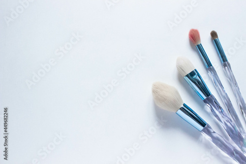 Brushes a flat lay with copy space. Beauty cosmetic makeup product layout. Stylish design. Creative fashionable concept. Cosmetics make-up brushes collection on a white background, top view. 