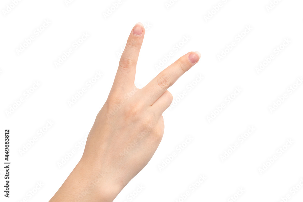 Hand gesture victory sign, two fingers, isolated on a white background, young female hand close-up Hand gesture victory sign, two fingers, isolated on a white background, young female hand close-up