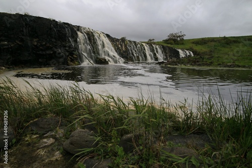 a large waterfall over a body of water