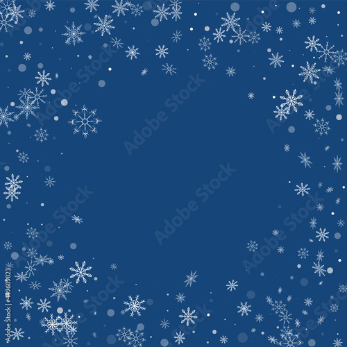 White delicate openwork snowflakes are scattered on a blue background. Festive background, postcard design, wallpaper