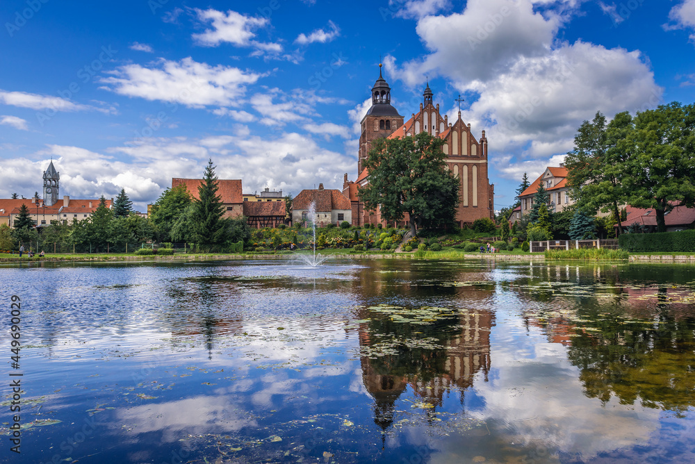 Pond and St Anne and St Stephen Roman Catholic gothic church in Barczewo town, Poland