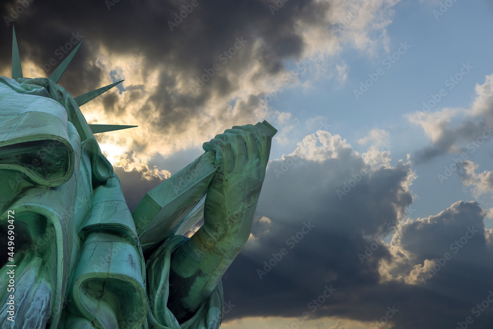 Fototapeta premium Statue of Liberty with beautiful colorful orange sky sunset in Manhattan New York City
