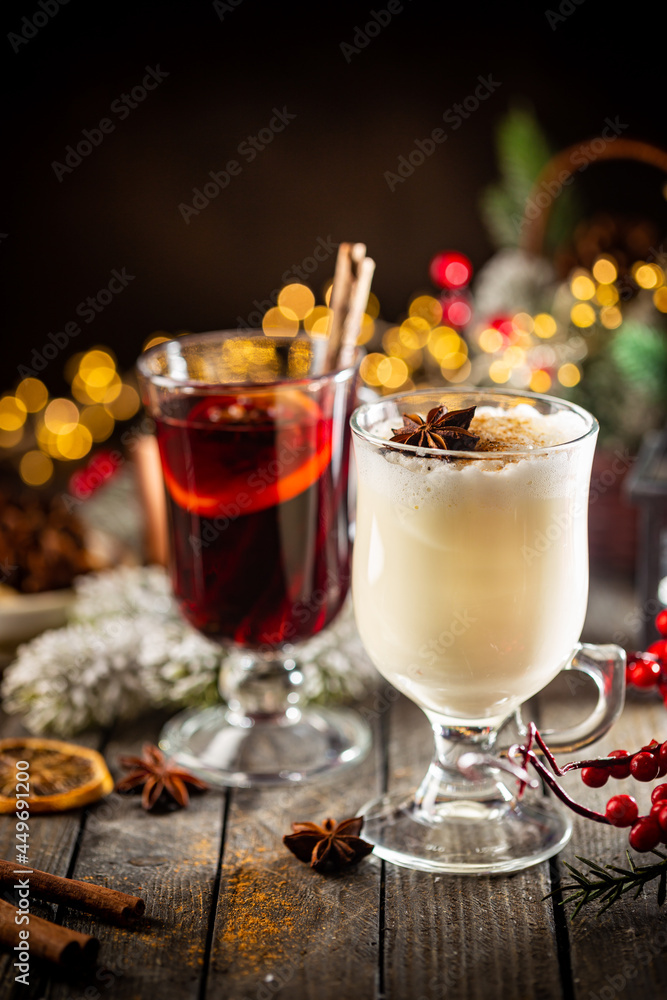 fresh yellow eggnog and fruity red mulled wine with Christmas decoration. Selection of autumn or winter alcoholic hot drinks fresh yellow eggnog and fruity red mulled wine with Christmas decoration. Selection of autumn or winter alcoholic hot drinks