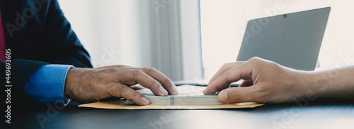 Фотография Government officials hand receiving bribe money from businessman, the concept of