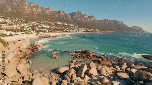 Aerial: Camps Bay and surfers at sunset, Cape Town, South Africa
