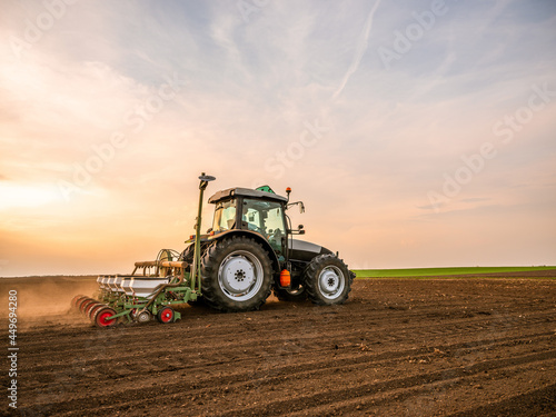 Farmer seeding  sowing crops at field. Sowing is the process of planting seeds in the ground as part of the early spring time agricultural activities.