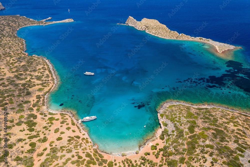 Aerial view of an island surrounded by beautiful, clear blue ocean in summer (Kolokitha, Crete, Greece)
