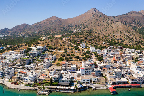 ELOUNDA, CRETE/GREECE - JULY 16 2021: Aerial view of the port and resort town of Elounda on the Greek island of Crete photo