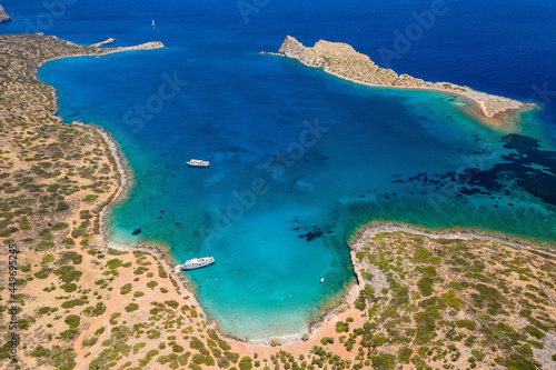 Aerial view of an island surrounded by beautiful, clear blue ocean in summer (Kolokitha, Crete, Greece)