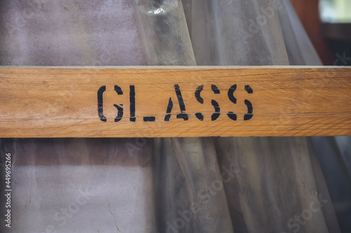 Closeup of a wooden signboard with GLASS text photo