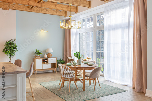 modern expensive luxurious open-plan apartment. Rich Scandinavian-style interior with wooden beams on the ceiling in pastel colors