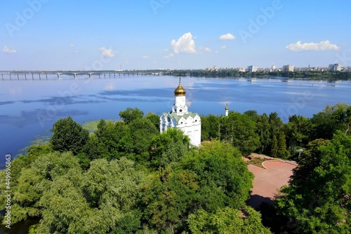 A beautiful view from a drone on the river and white Christian church on Monastery island in Ukrainian city Dnipro, Dnepropetrovsk, Ukraine, summer, spring landscape.