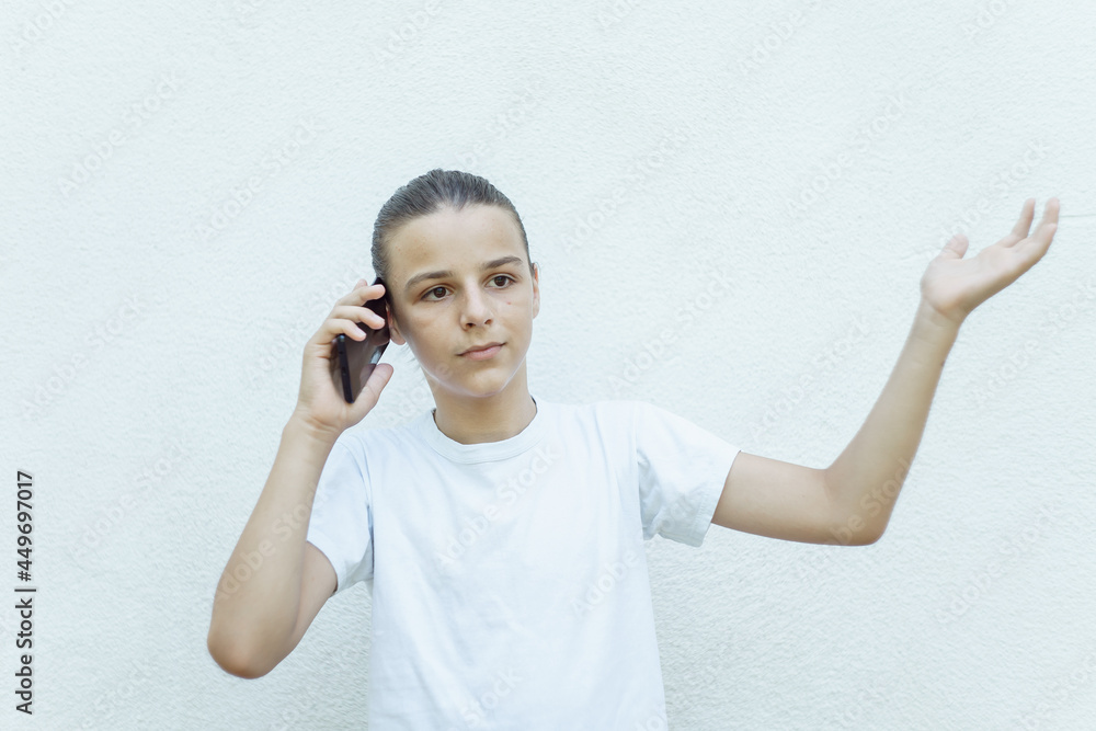 photo boy with a mobile phone in various poses, the concept of modern life, portrait isolated on white background photo boy with a mobile phone in various poses, the concept of modern life, portrait isolated on white background