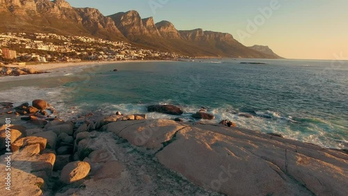 Aerial: Camps Bay and surfers at sunset, Cape Town, South Africa