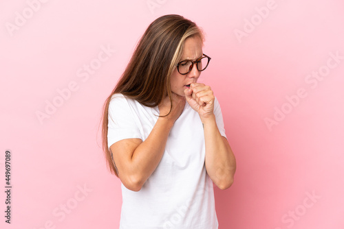 Young English woman isolated on pink background coughing a lot