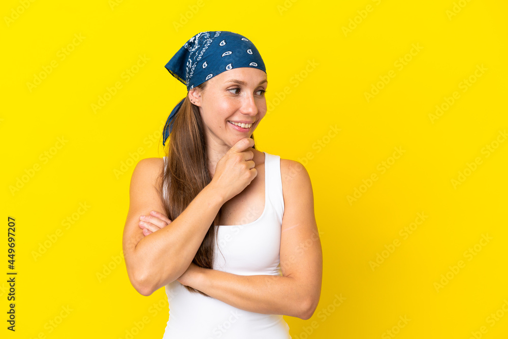 Young English woman isolated on yellow background looking to the side and smiling Young English woman isolated on yellow background looking to the side and smiling