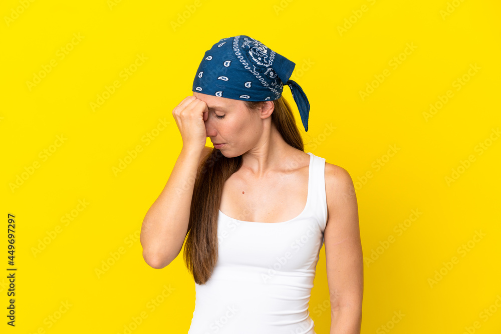 Young English woman isolated on yellow background with headache Young English woman isolated on yellow background with headache