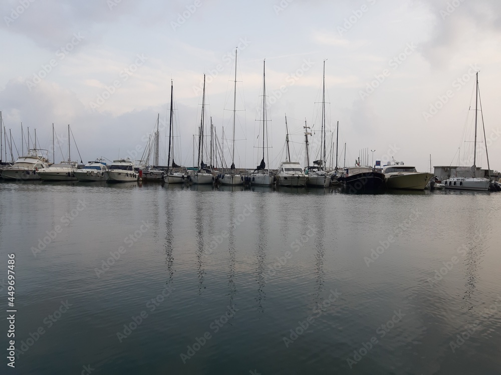 Genova, Italy - July 26, 2021: Travelling around the ligurian seaside. Panoramic view to the seaside and the old port. Beautiful view to the port with some boats in summer days.