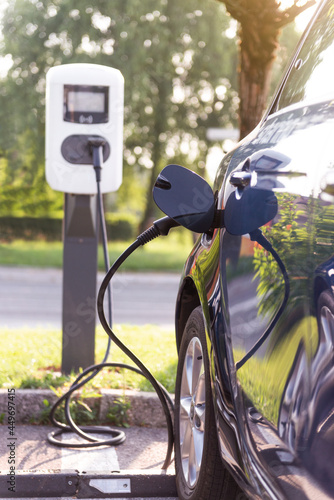  electric cars charging in outdoors charging station
