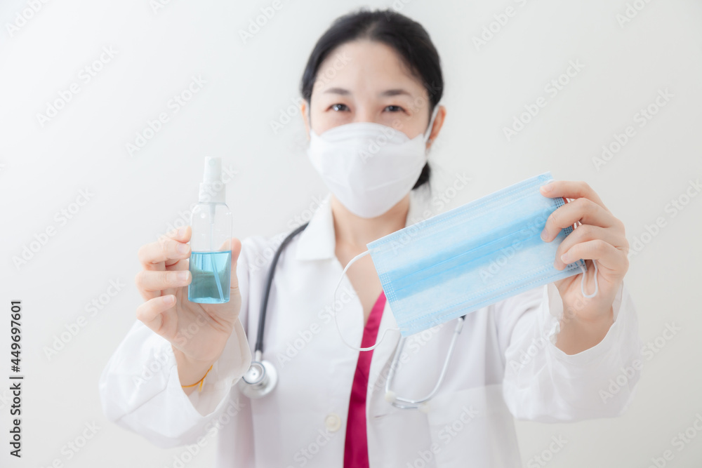 Asian female doctor is recommending medication, wearing a mask and checking body temperature while examine the patient via video call. Health care and prevention COVID-19 strategy Coronavirus concept Asian female doctor is recommending medication, wearing a mask and checking body temperature while examine the patient via video call. Health care and prevention COVID-19 strategy Coronavirus concept
