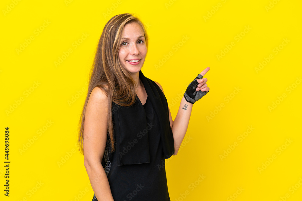 Young sport English woman isolated on white background pointing finger to the side Young sport English woman isolated on white background pointing finger to the side