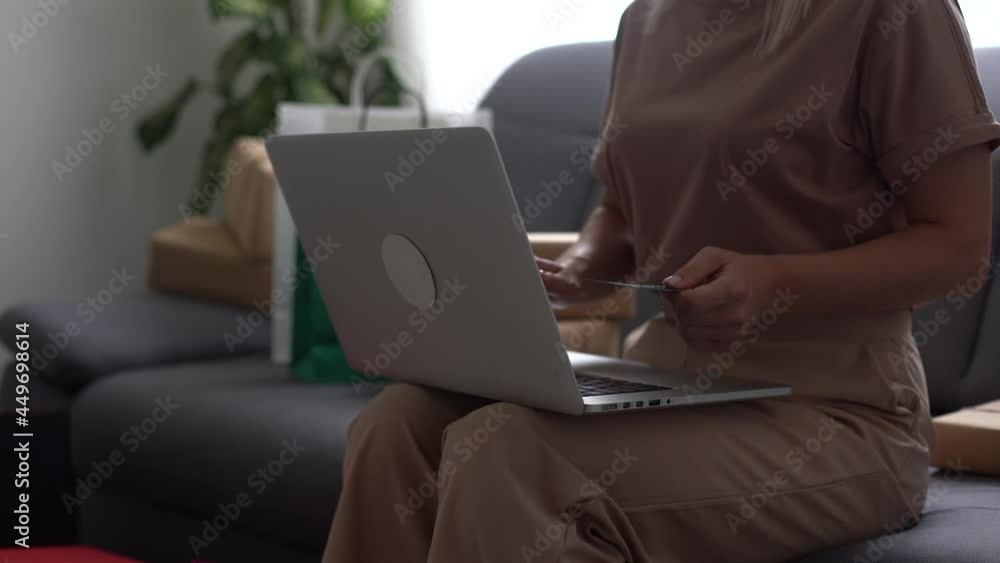 Female hands of cardholder holding credit card making e bank online payment. Woman consumer paying for purchase in web store using laptop technology. Ecommerce website payments concept Female hands of cardholder holding credit card making e bank online payment. Woman consumer paying for purchase in web store using laptop technology. Ecommerce website payments concept