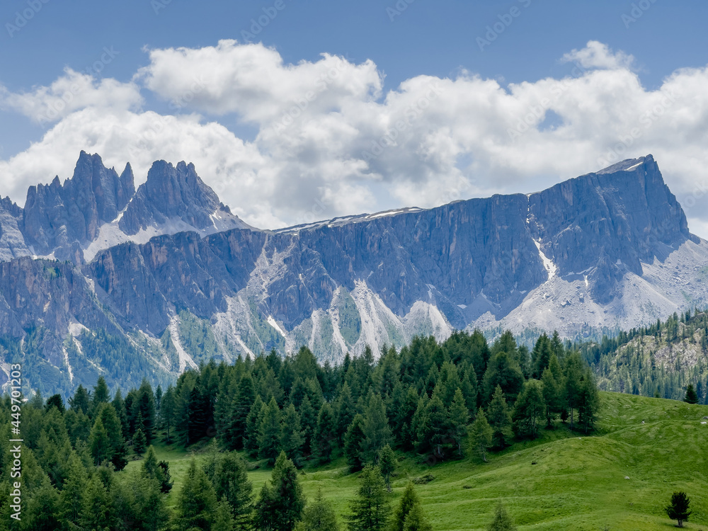 Picturesque Dolomite Alps formation Landscape photo with green spruces hill near Cinque Torri in South Tyrol, Italy. Beauty in Nature and mountain concept image.