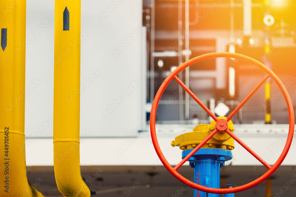 Round red valve close-up. Industrial background. Gasification or transportation and supply of natural gas. Round red valve close-up. Industrial background. Gasification or transportation and supply of natural gas.
